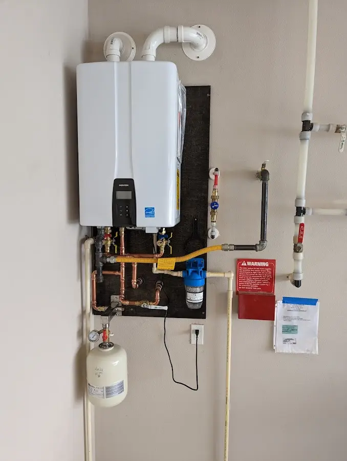 Professional plumber installing copper piping in a Mount Hood Villages home